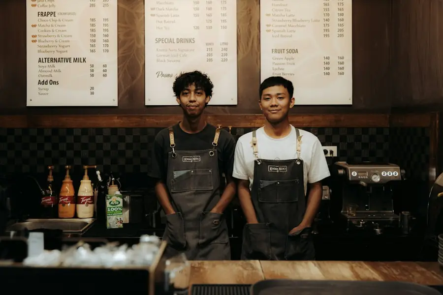 Two baristas behind a cafe counter
