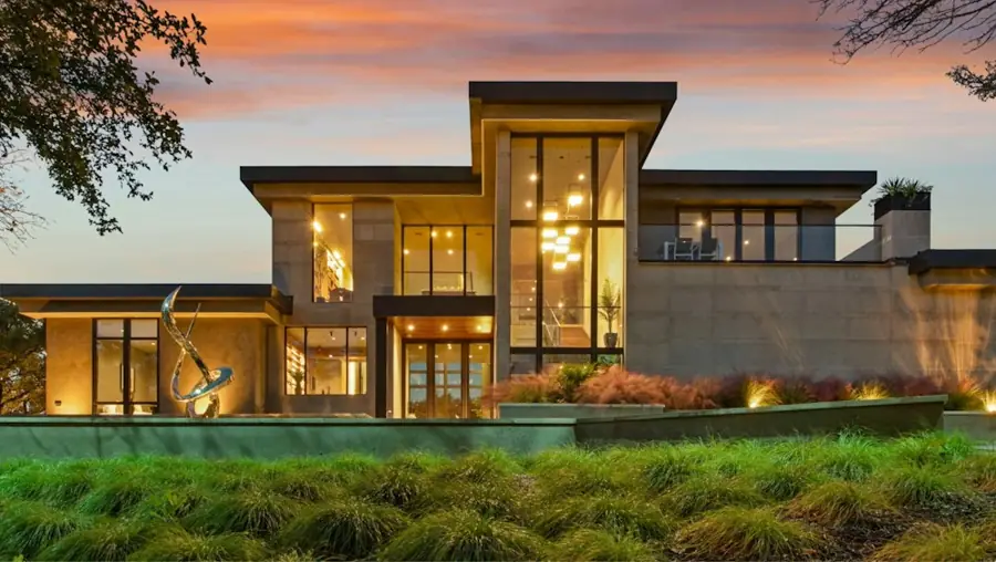 A family home lit up at dusk